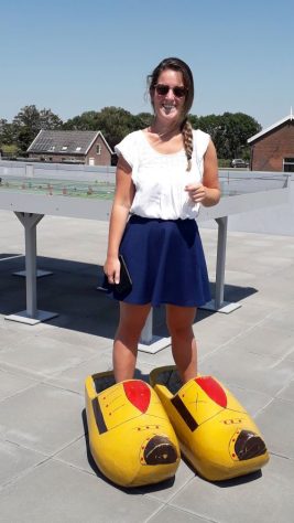 A woman standing in wooden clogs