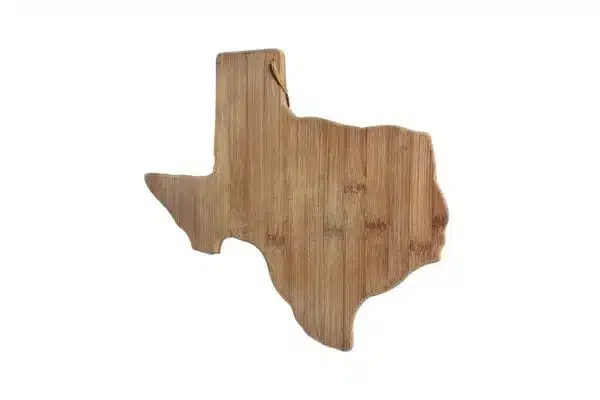 A bamboo cutting board in the shape of the map of Texas