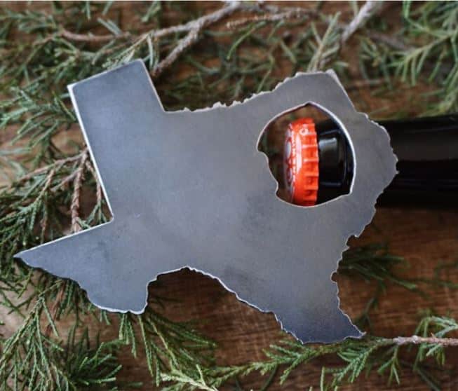 A metal bottle opener in the shape of the map of Texas