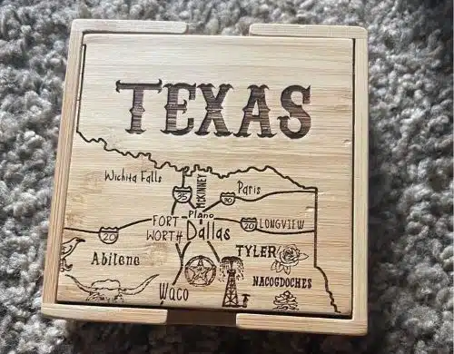 A wooden coaster with a part of the map of Texas
