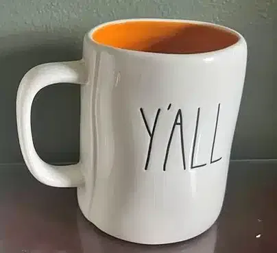 A white coffee mug with the word "y'all"
