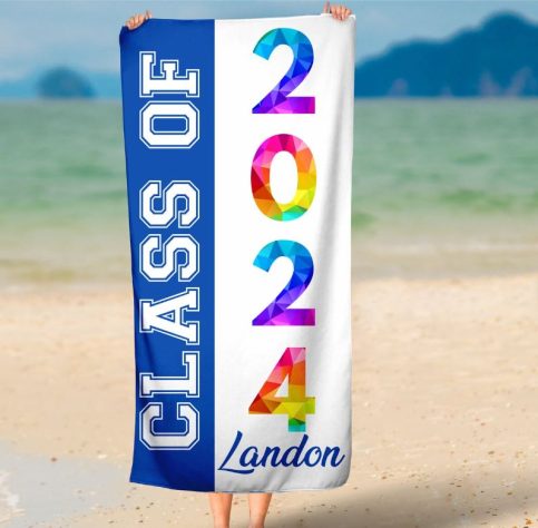 Woman holding a beach towel with "class of 2024"