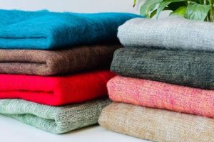 Yak wool blankets in different colors on a pile