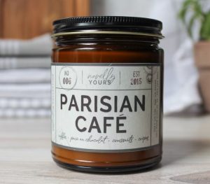 A candle with a label of "Parisian cafe"