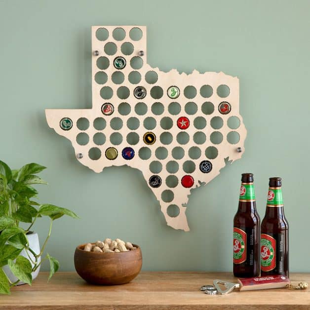 A map of texas with holes for beer caps